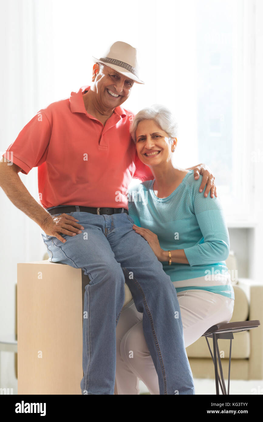 Smiling senior couple sitting together Stock Photo