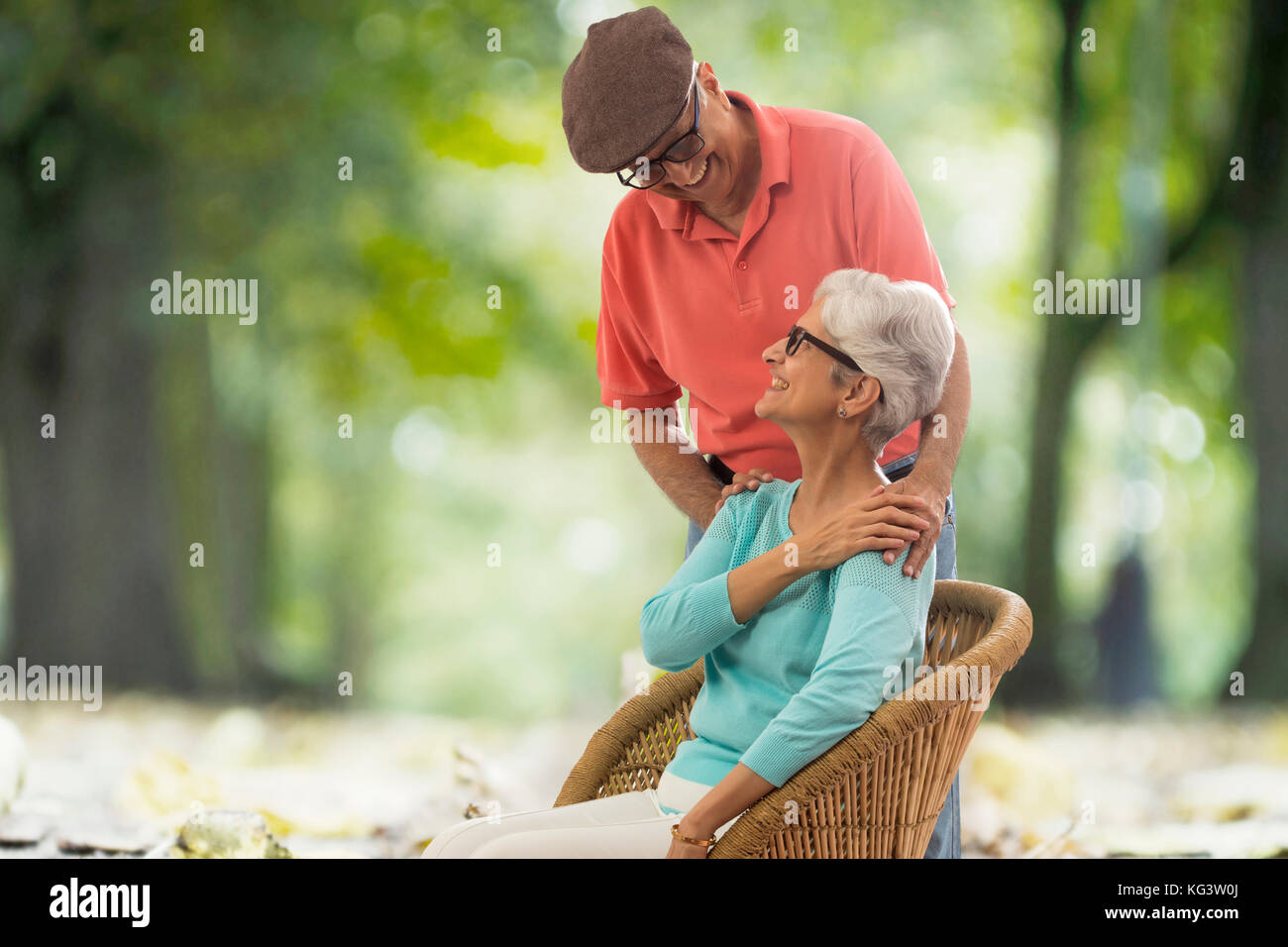 Senior couple enjoying nature outdoors sitting  on wicker chair Stock Photo