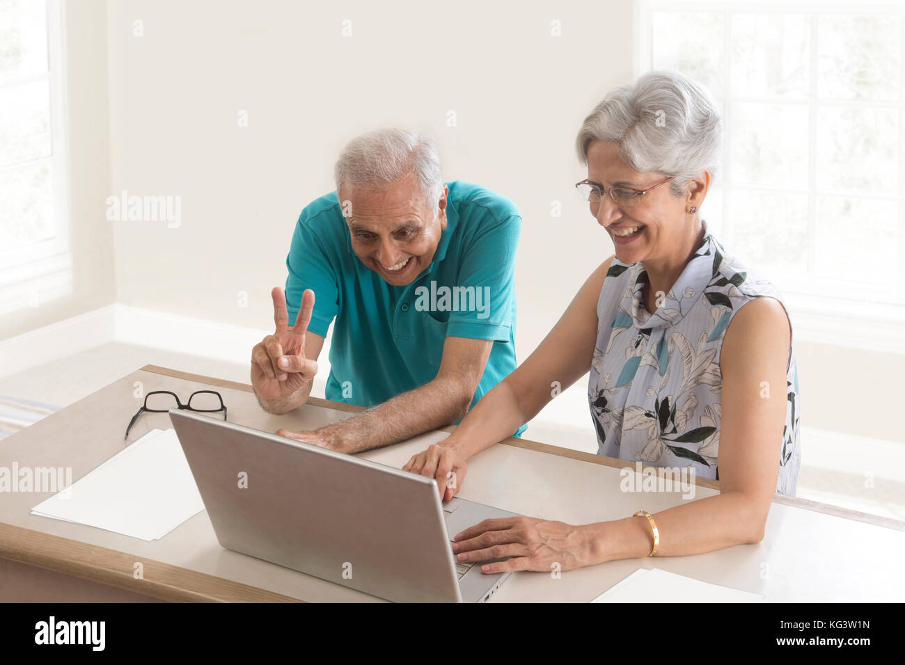 Senior couple using webcam on laptop Stock Photo