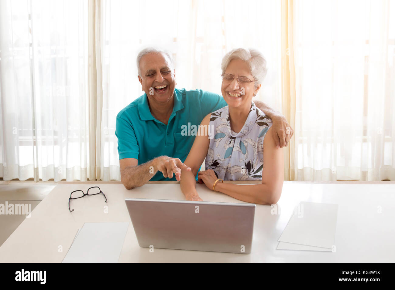 Senior couple video chatting on laptop Stock Photo