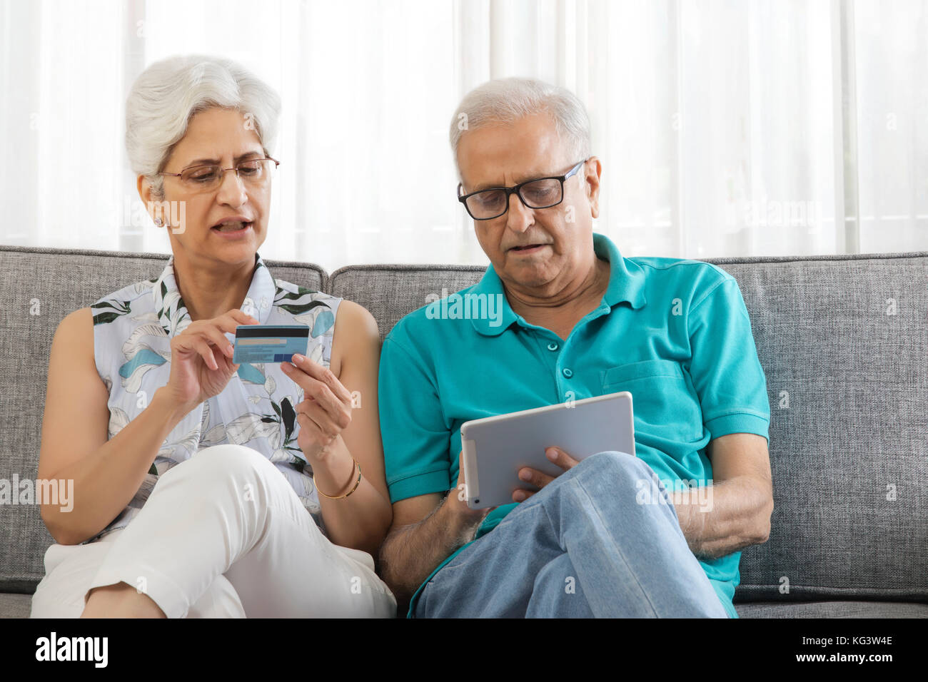 Senior couple shopping online using credit card on digital tablet Stock Photo