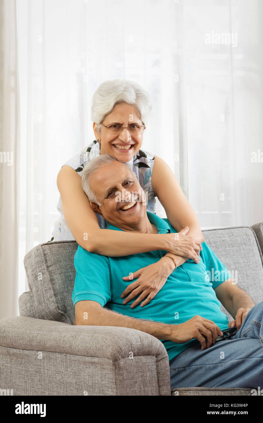 Senior woman embracing senior man Stock Photo