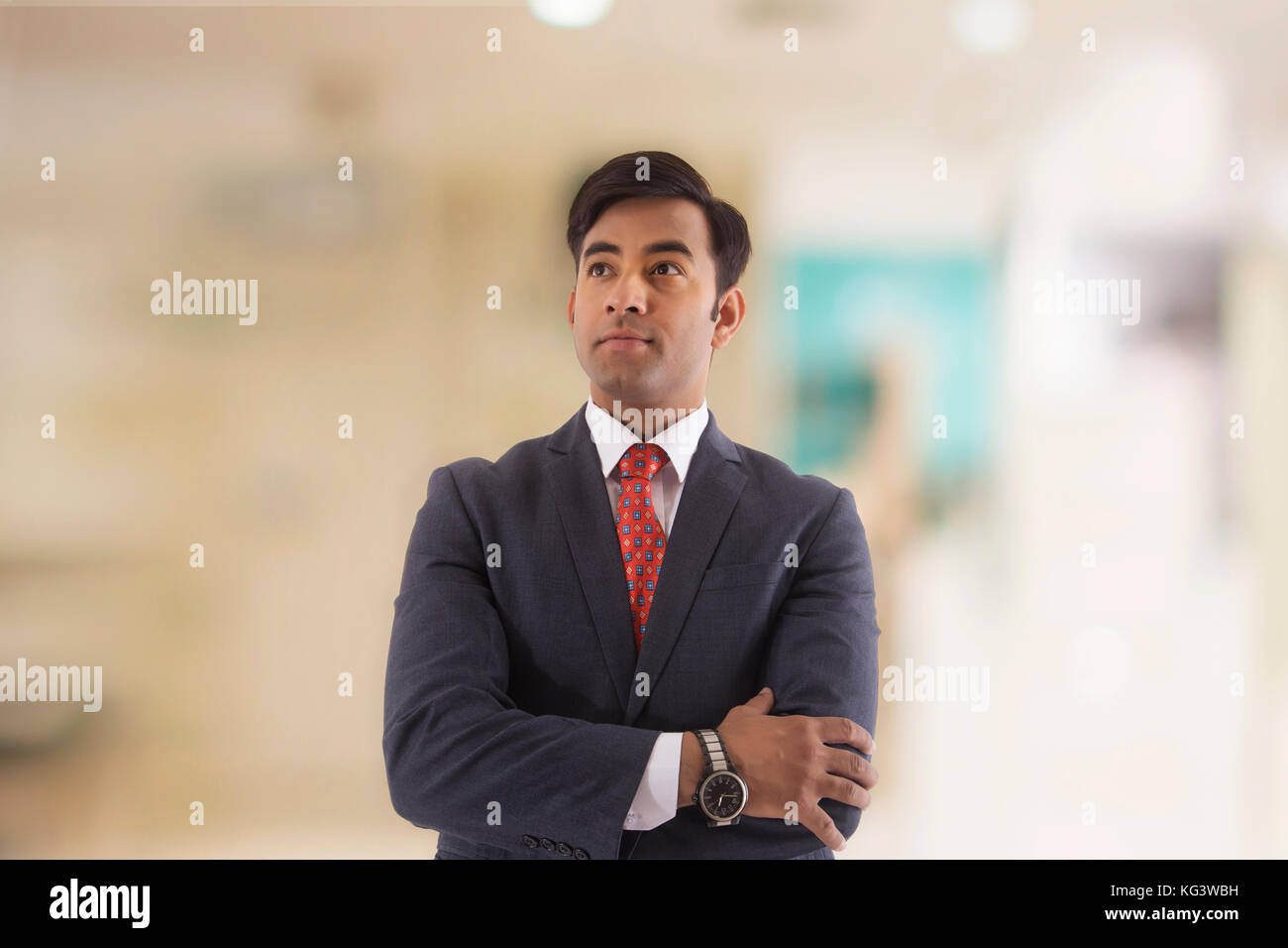 Portrait of confident businessman with arms crossed looking up Stock ...