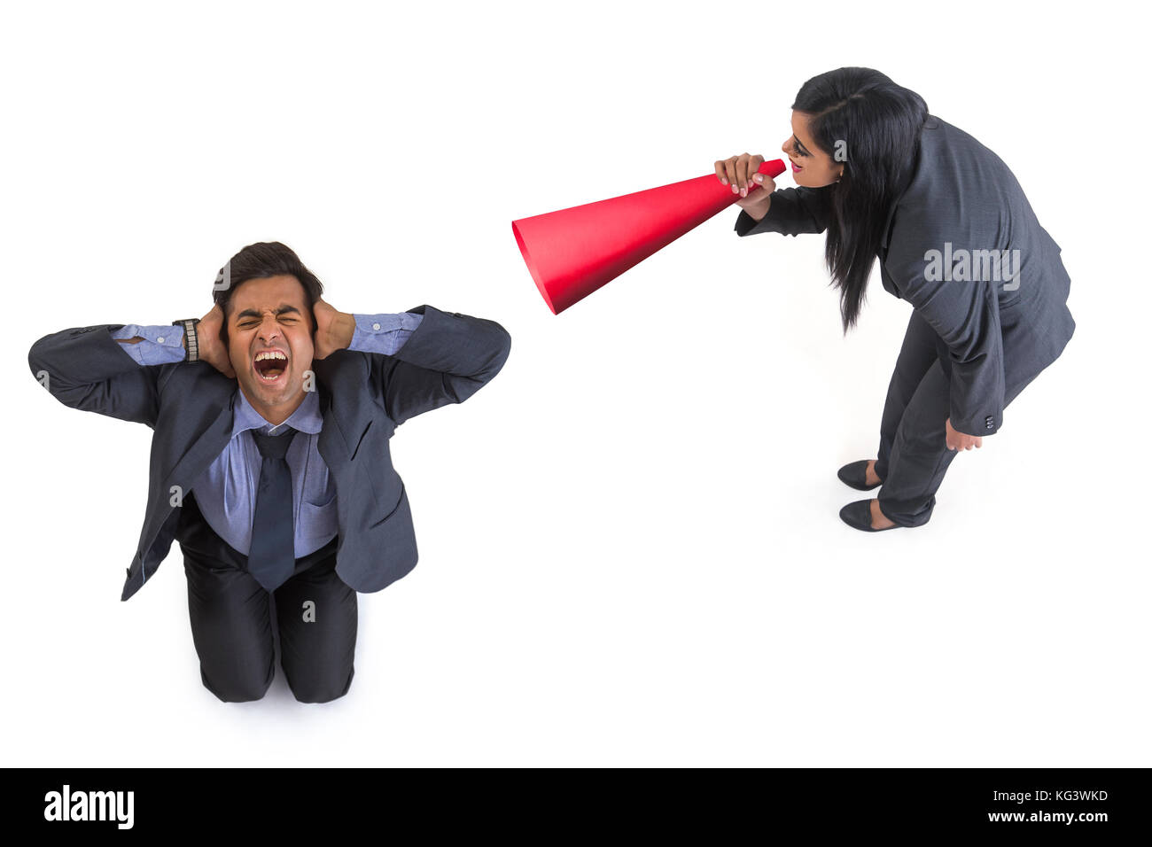 Businesswoman shouting through megaphone on businessman Stock Photo