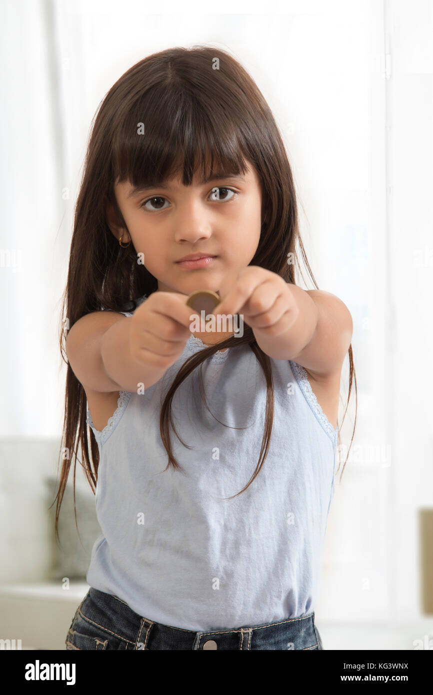 Portrait of girl holding coin Stock Photo