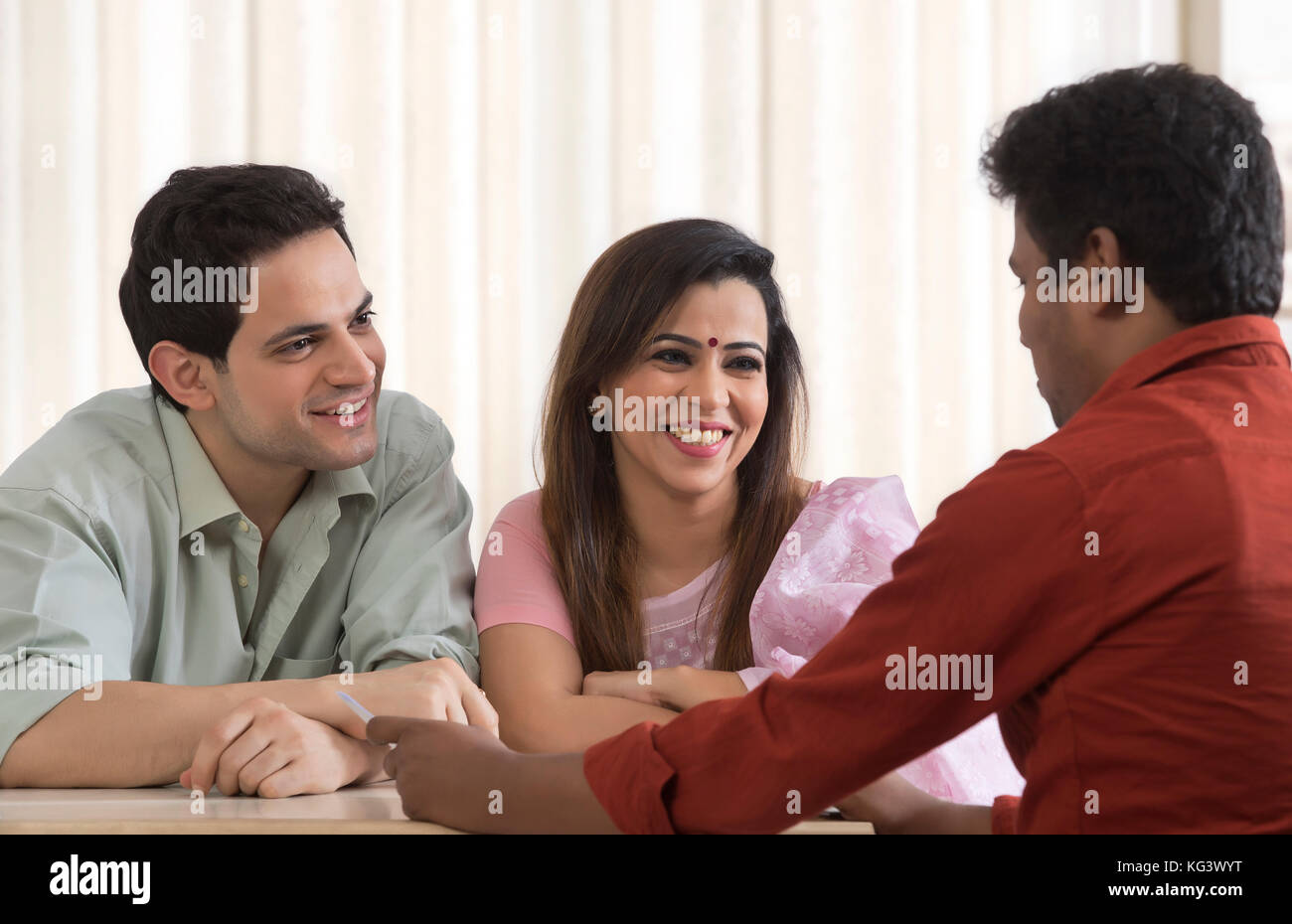 Couple receiving financial consultation Stock Photo