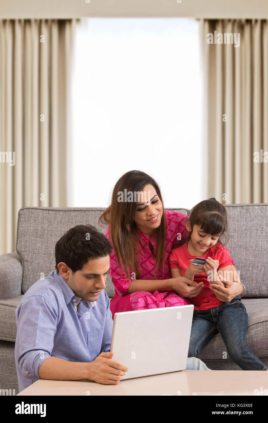 Family using credit card for shopping online Stock Photo