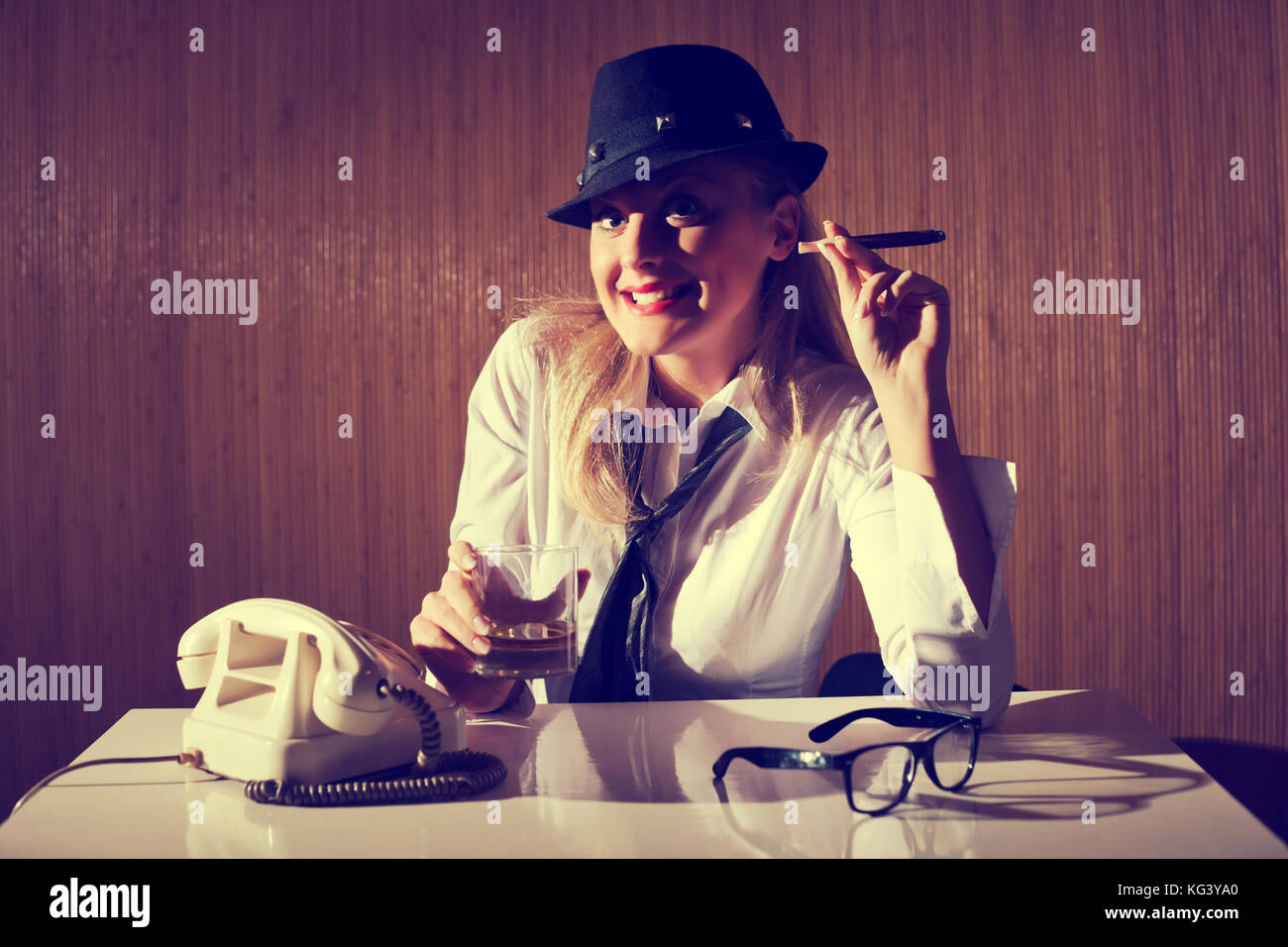 Retro styled businesswoman smoking cigar and talking on telephone. Stock Photo