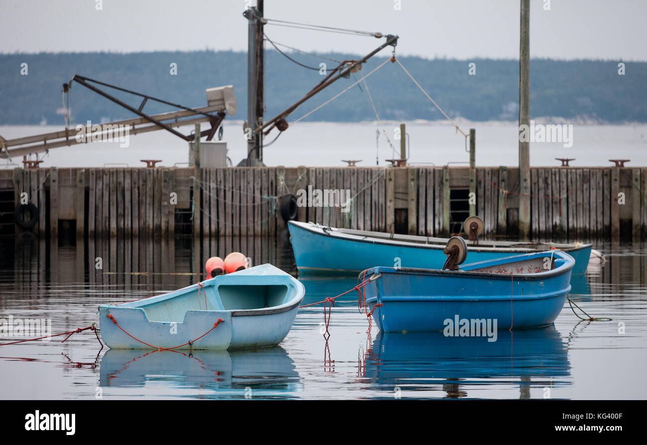 Nova Scotia, Canada - August 30, 2017: Finihsed their work for the day, fishing boats and trawlers sit tied up in small fishing villages along the sou Stock Photo