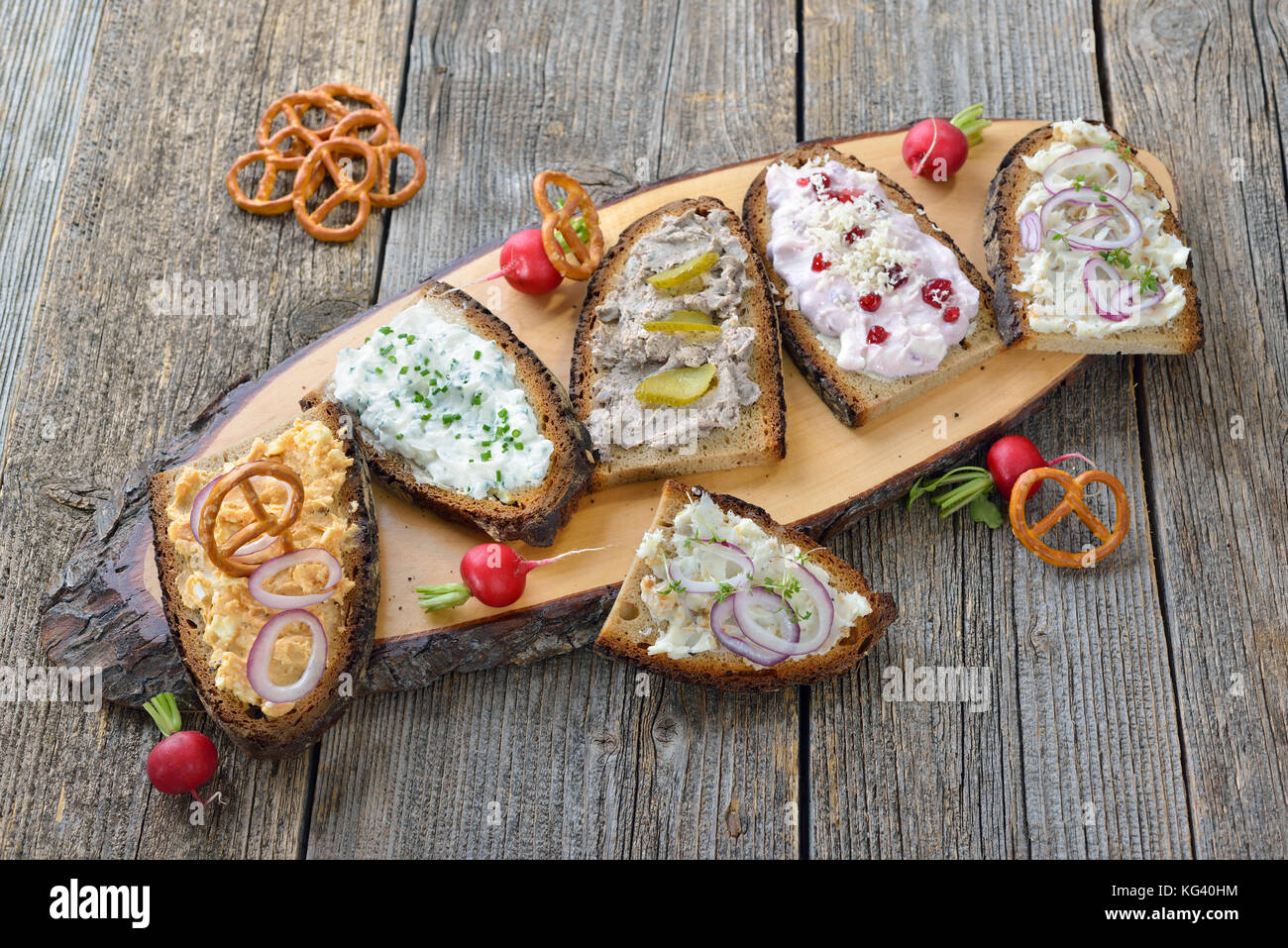 Hearty snack with different kinds of spreads on farmhouse bread served