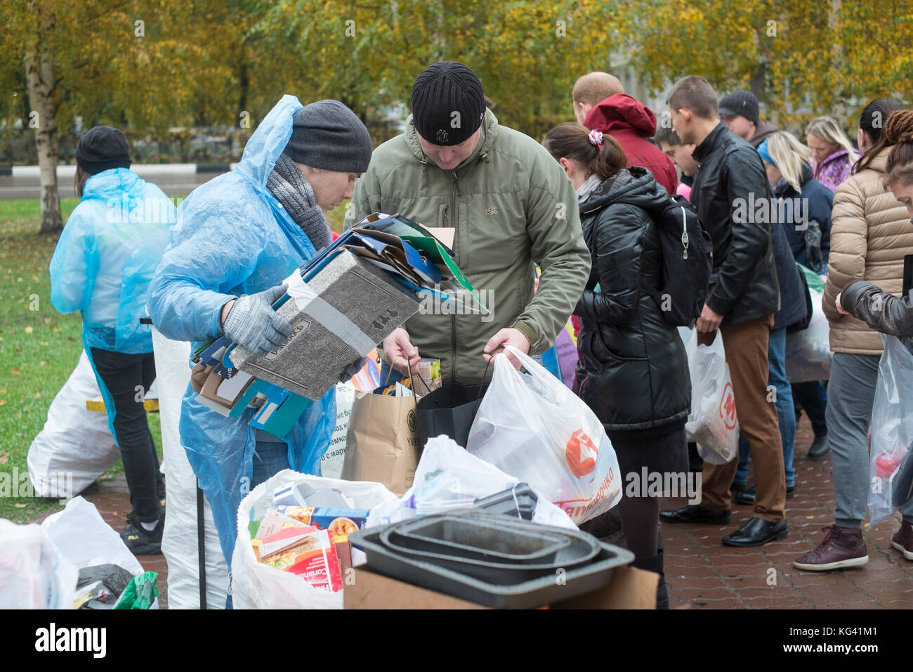 Volunteers collect household waste for recycling in a square in the town of Zheleznodorozhny, Moscow province, Russia. Local inhabitants have sorted their waste in advance at home in preceding weeks and can leave it in separate bags or containers here, for further transportation and recycling elsewhere. For now, the volunteers come here once a month, but the idea gains popularity. Waste sorting is still uncommon in Russia, where some ninety percent of household waste ends up at huge, open rubbish dumps. Stock Photo