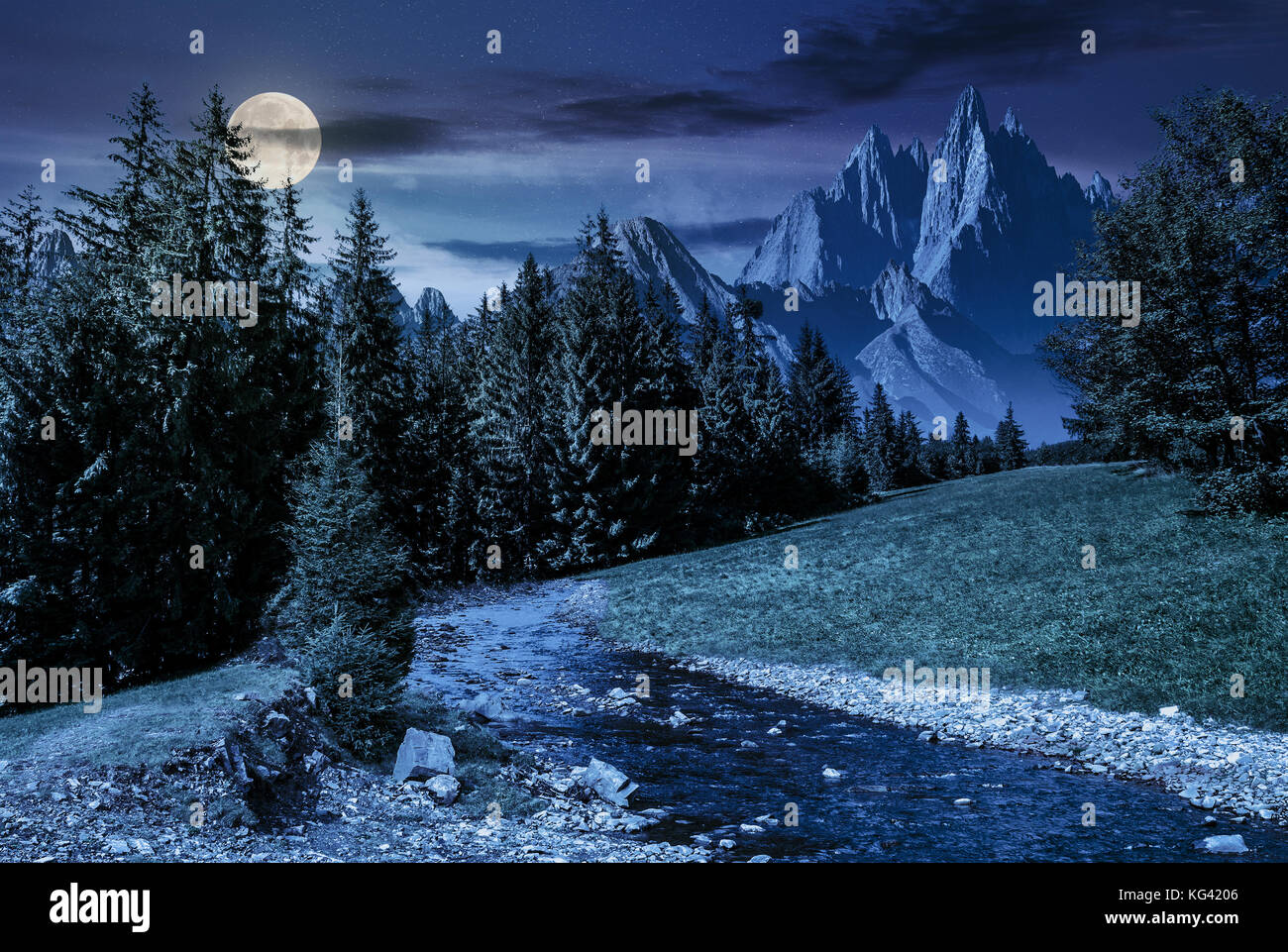 fairy tale mountainous summer landscape at night in full moon light. composite image with high rocky peaks above the mountain river in spruce forest Stock Photo