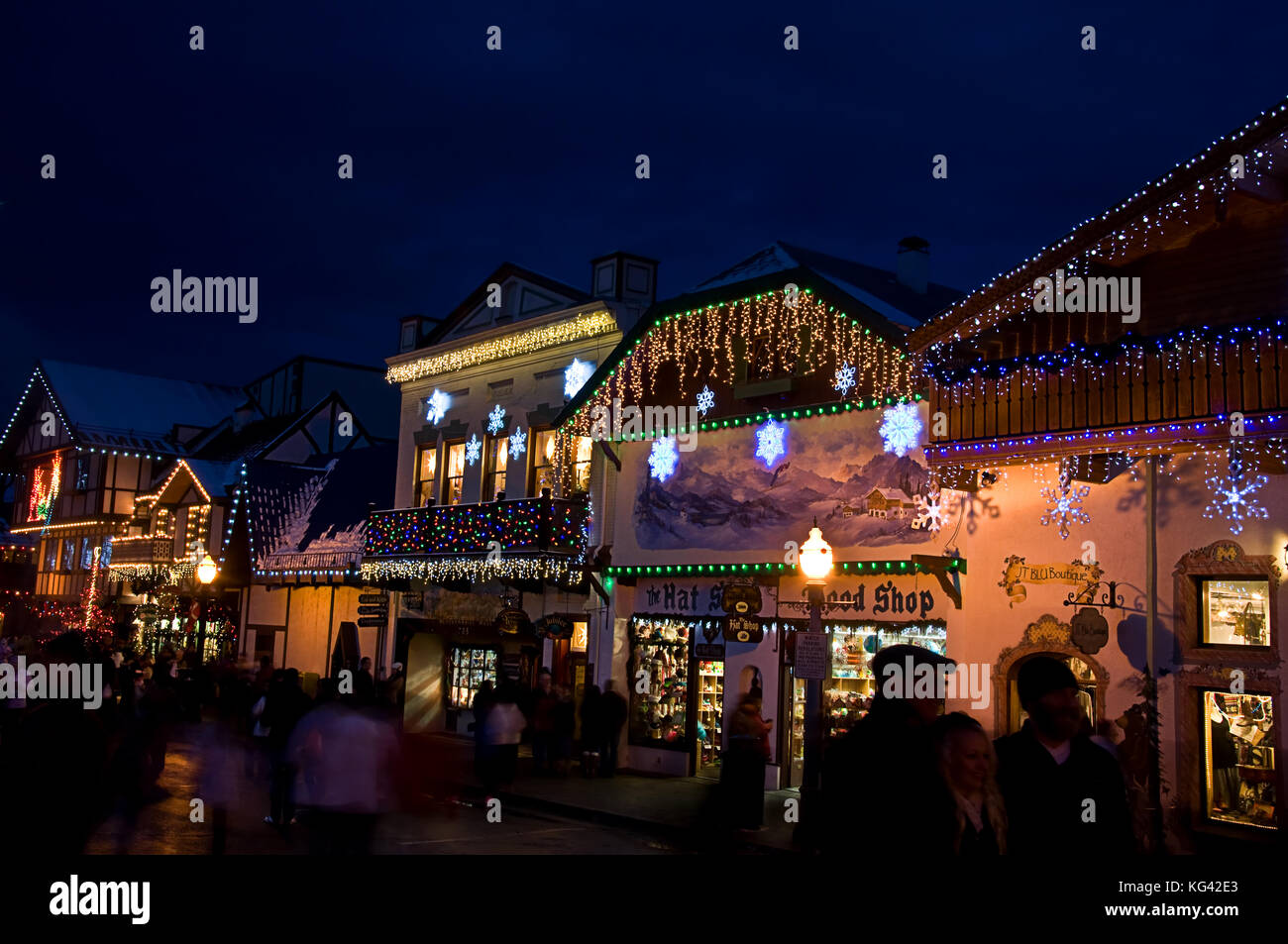 This is a Bavarian store lit up with Christmas lights at night with shoppers.  Very popular tourist attraction in Leavenworth, Washington USA. Stock Photo