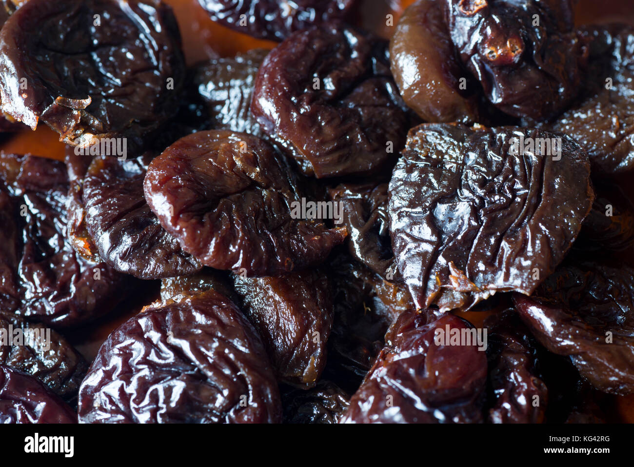 dried plums on plate closeup Stock Photo Alamy