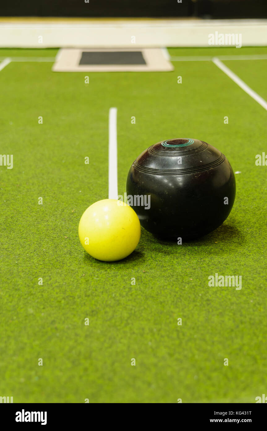 Bowl and jack on an indoor bowls carpet Stock Photo