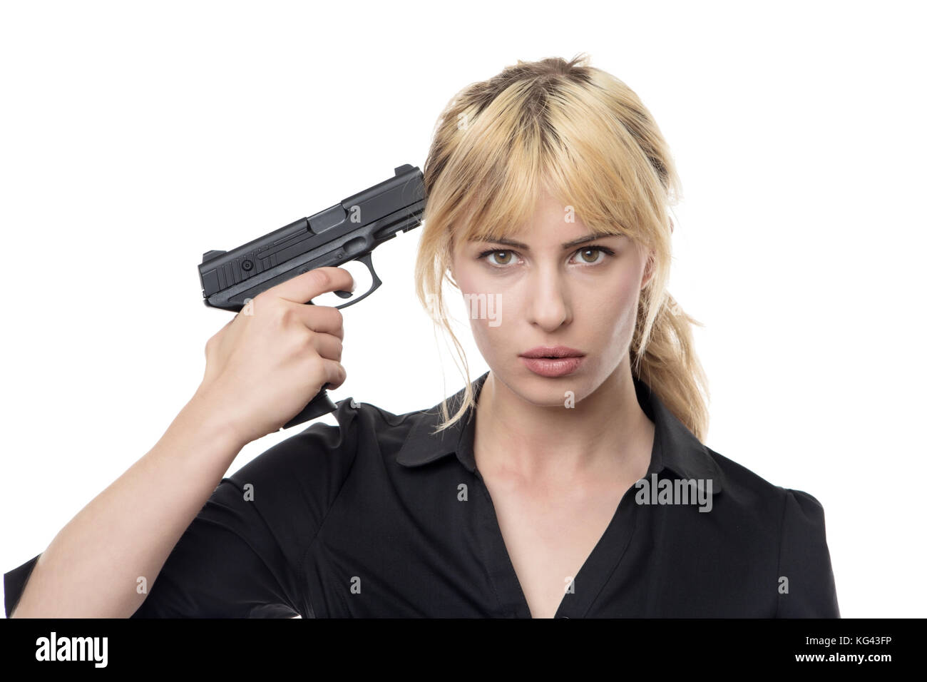 blonde haired business woman holding a gun up to her head Stock Photo