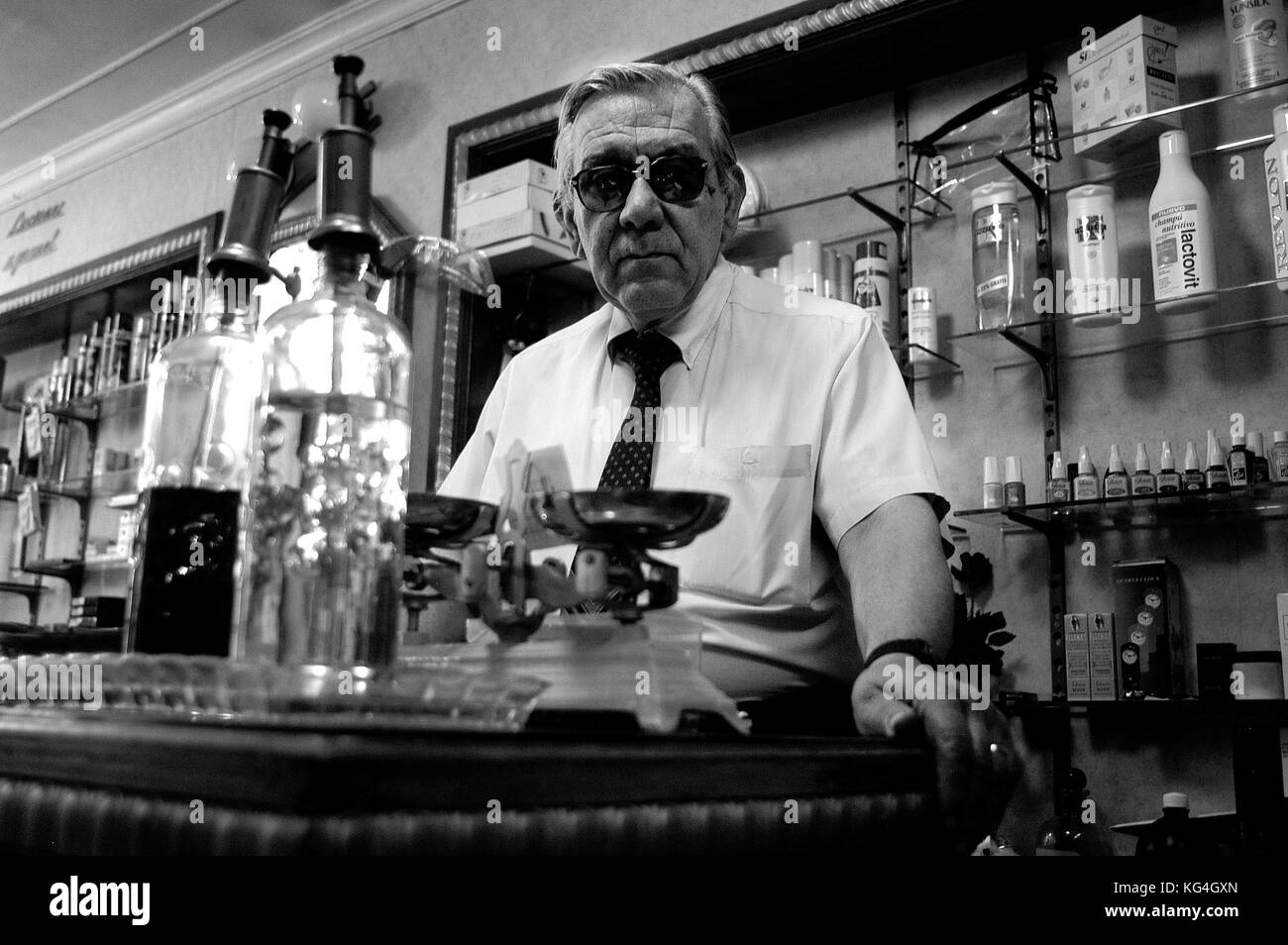 Portrait of Enric Blasco in what was his perfume store in Tallers street of Barcelona, Spain. Date: 09/2004. Photographer: Xabier Mikel Laburu. The grandfather of Enric Blasco inaugurated the shop in 1900. Enric remembers how he grew up with all the mells and had very clear he wanted to continue with the family tradition. In 1955 he started to work full time in the shop and would take over it when his father retired. Blasco closed the shop in January 2005 for retirement, his son did not what to take over the business. Stock Photo