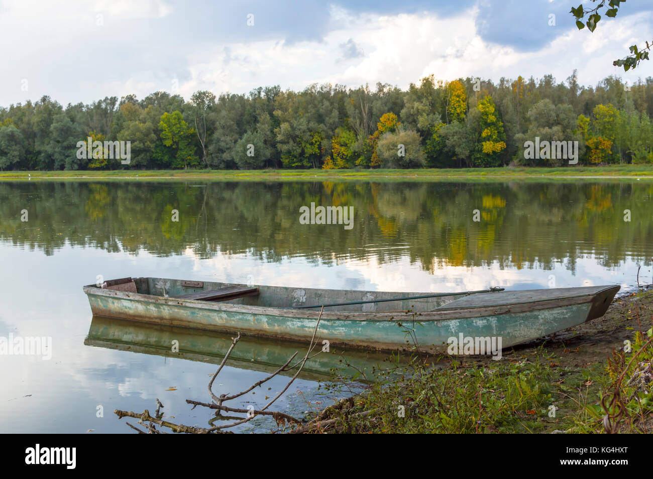 Old flooded wooden boat on the beach by the lake in the autumn Stock ...