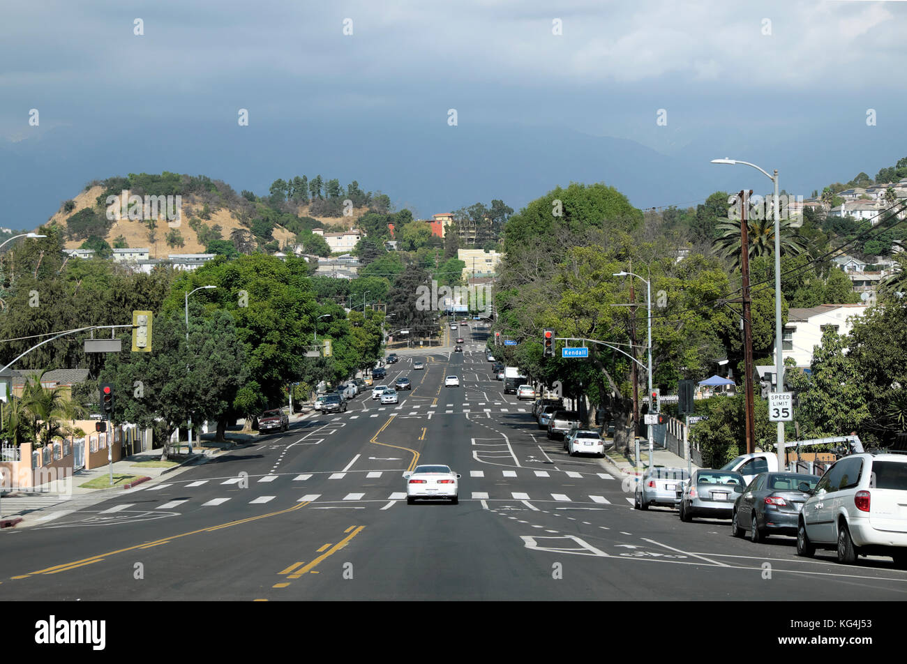 Wide street scene and hill hills cars on road in Highland Park area of LA  Los Angeles, California US  USA   KATHY DEWITT Stock Photo