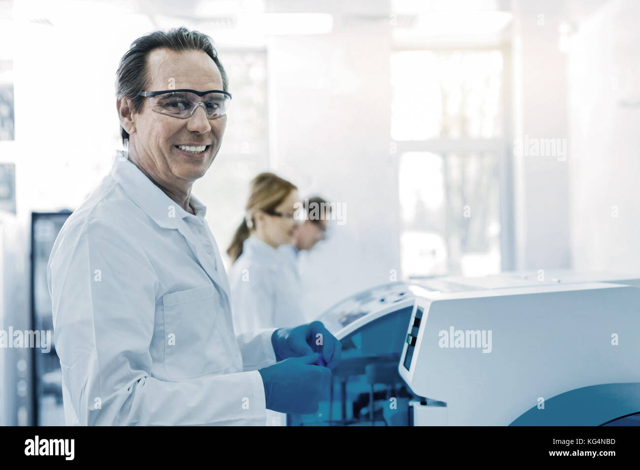 Positive handsome scientist being at work Stock Photo