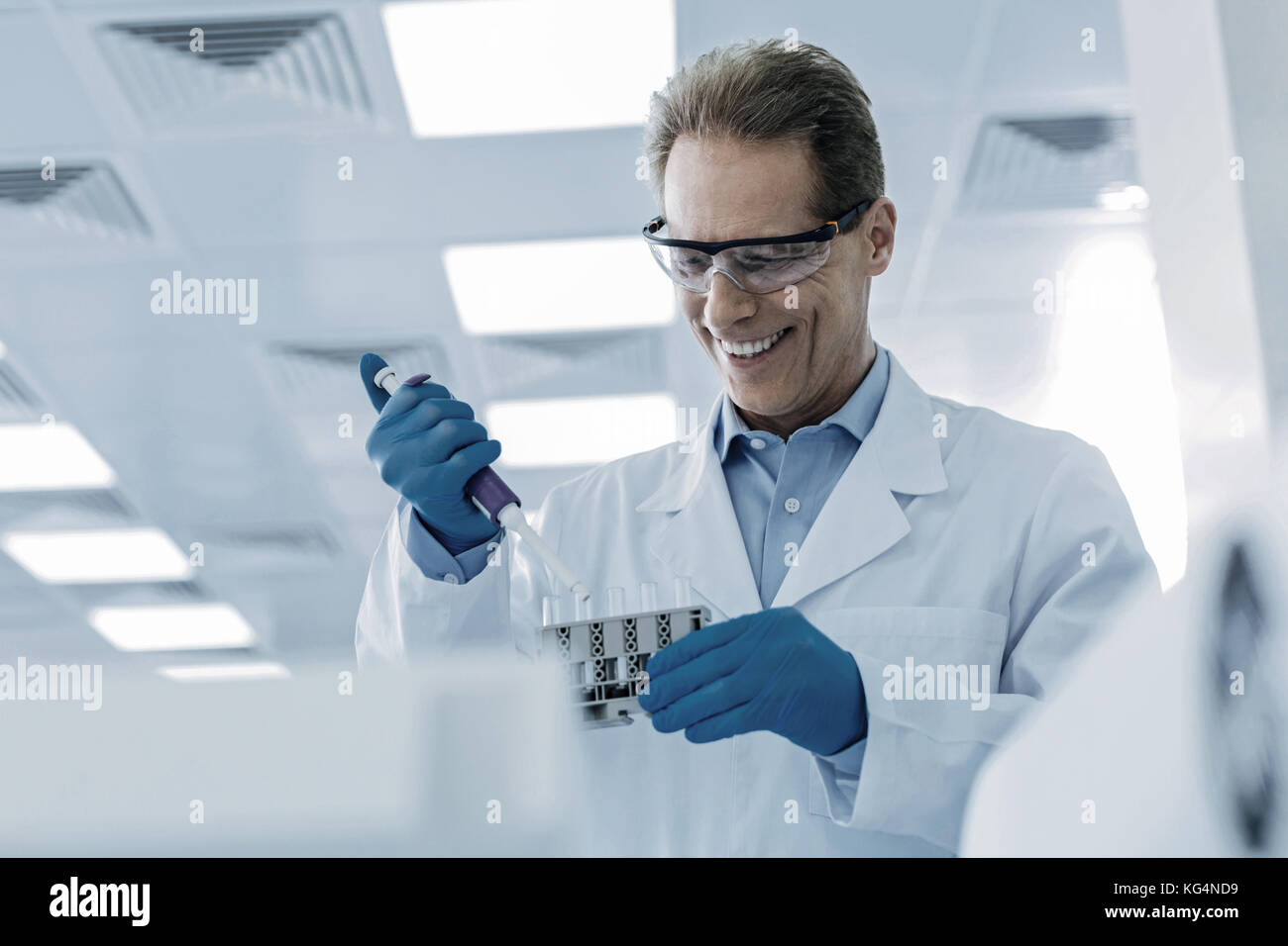 Cheerful nice scientist taking samples Stock Photo