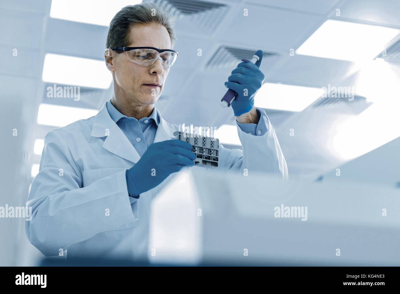 Handsome nice scientist focusing on his task Stock Photo