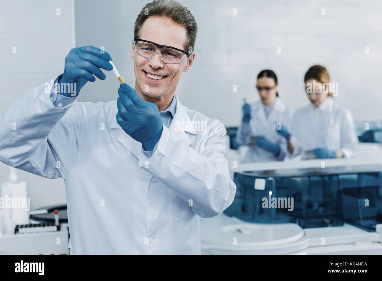 Happy professional scientist holding a test tube Stock Photo