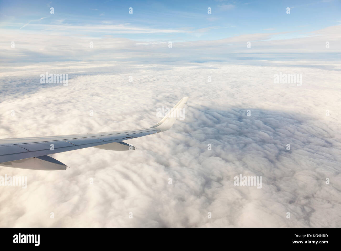Wing of an airplane above beautiful clouds Stock Photo - Alamy