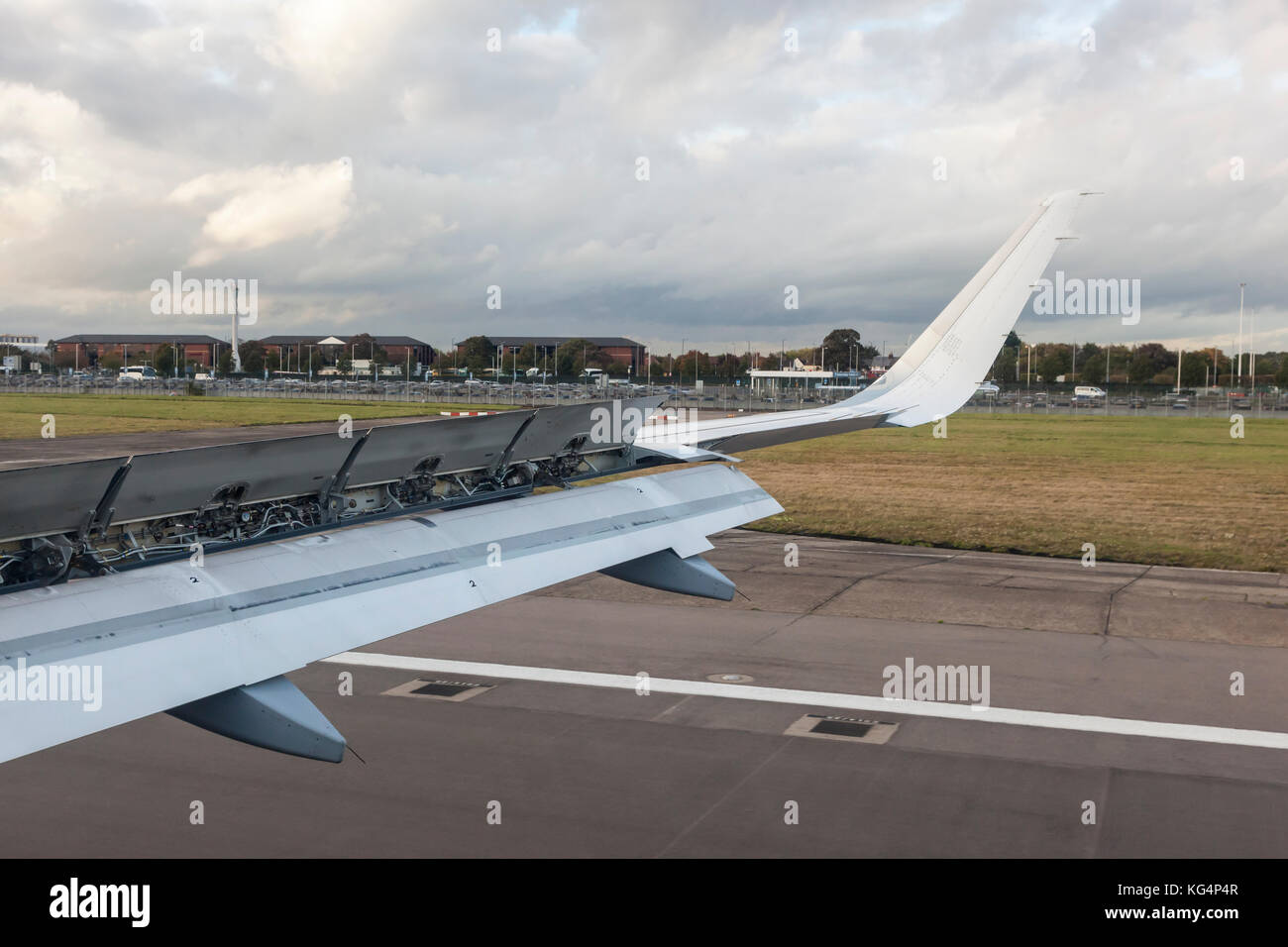 Airplane wing with raised up spoilers for braking after landing Stock Photo