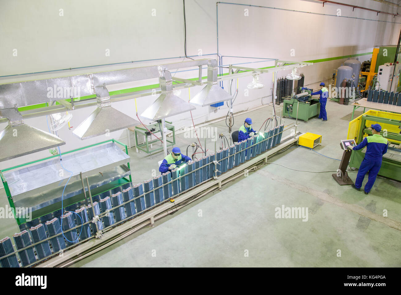 workers factory in the engaged in welding and soldering copper