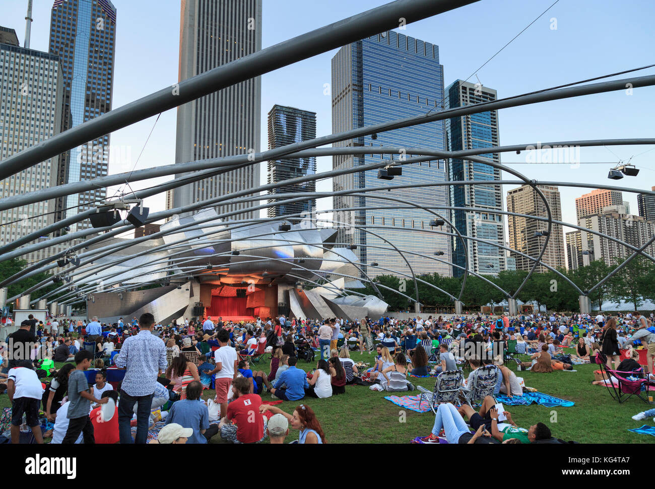 Millennium Park, crowd at Grant Park Symphony  the Jay Pritzker Pavilion, a bandshell designed by Frank Gehry, skyscrapers of the downtown on the back Stock Photo