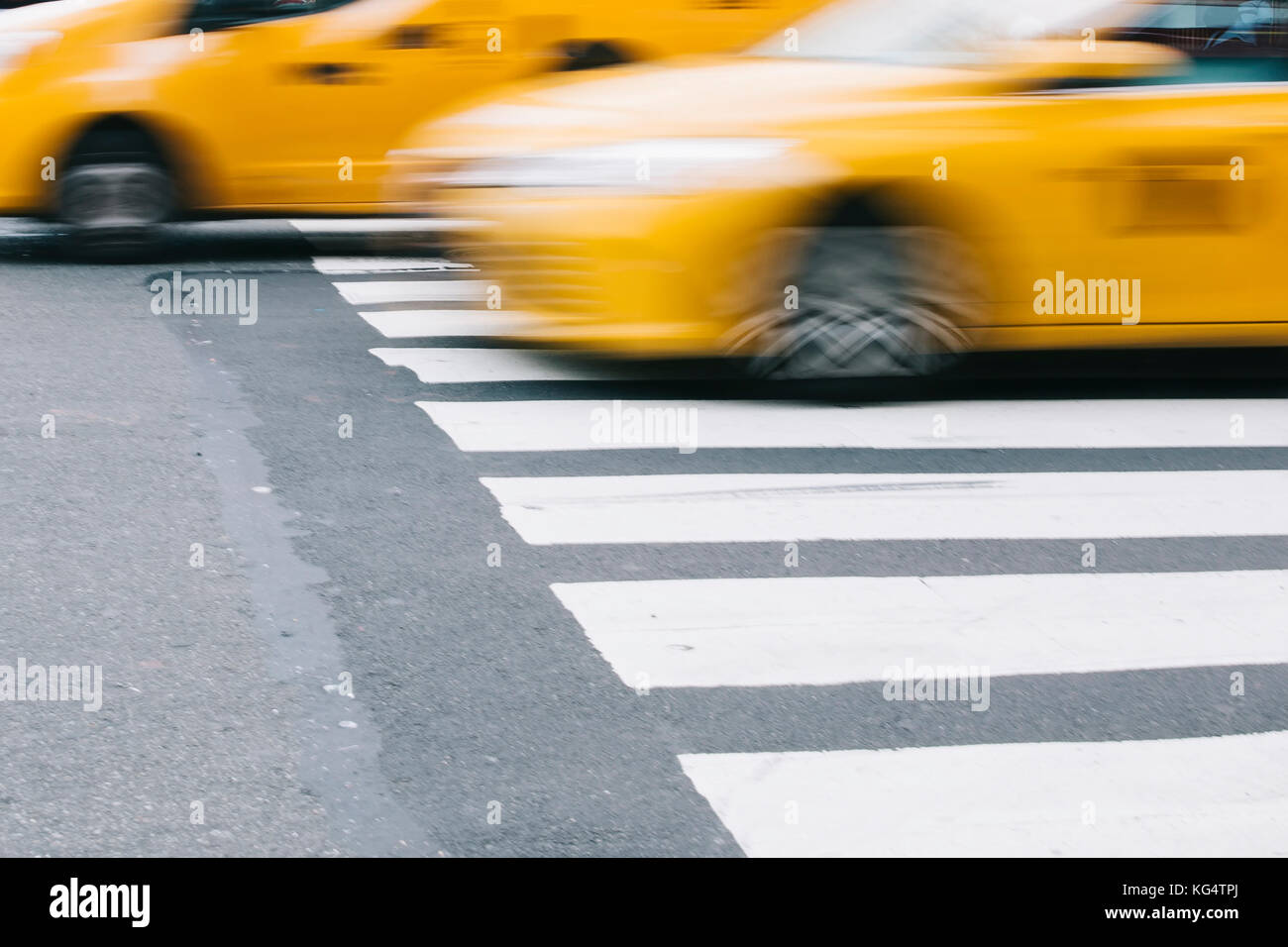 Abstract blur of urban street scene with a yellow taxi cab in New York ...