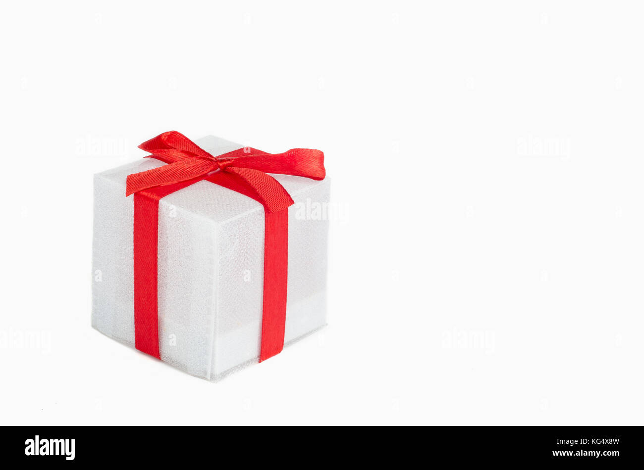 White gift box with red ribbon on white background Stock Photo - Alamy