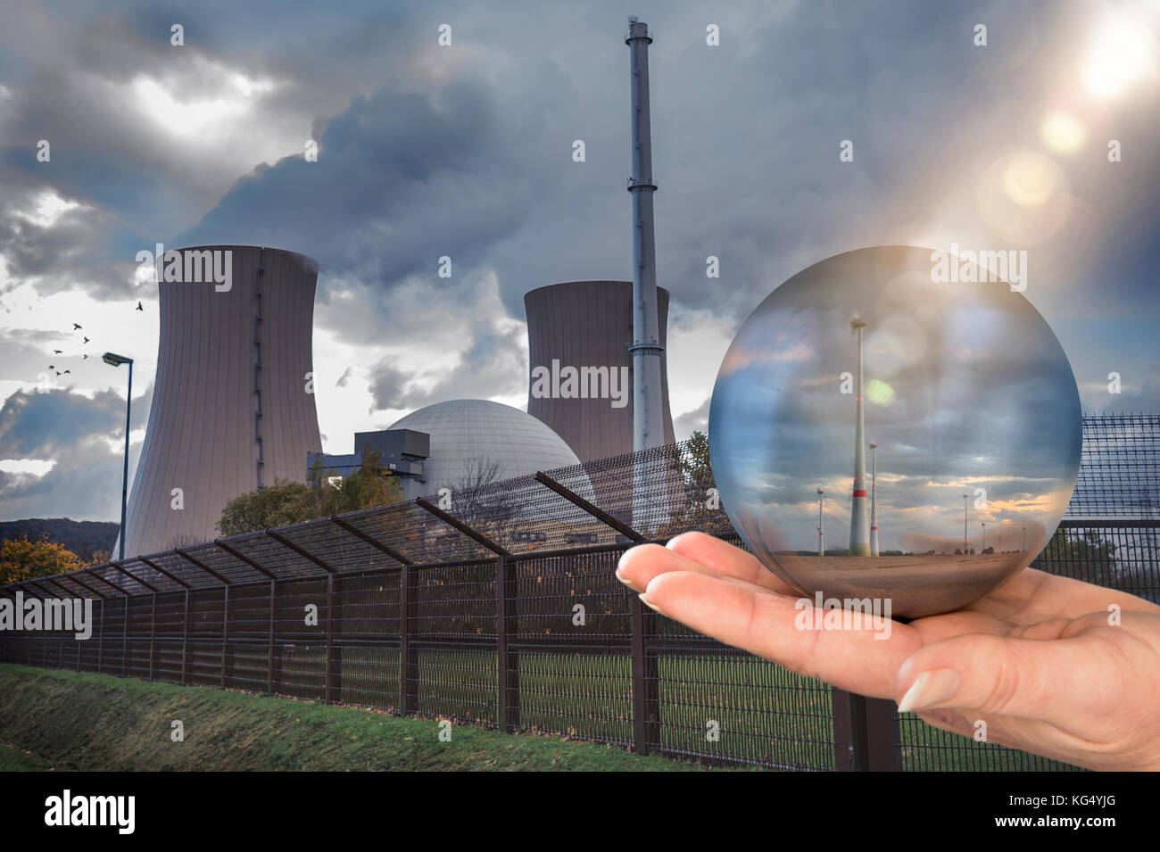 Glass sphere shows an alternative to nuclear stream with wind park Stock Photo