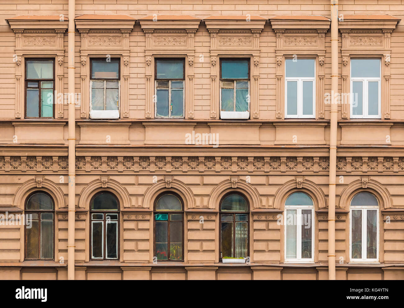 Several windows in a row on facade of urban apartment building front view, St. Petersburg, Russia Stock Photo