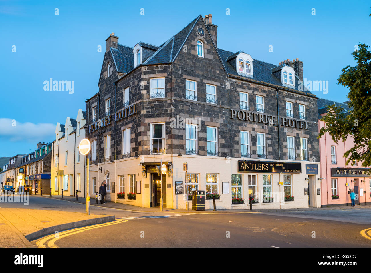 People read menu in front of a restaurant and a bar in downtown Portree,  Isle of Skye, Scotland, United Kingdom. Stock Photo