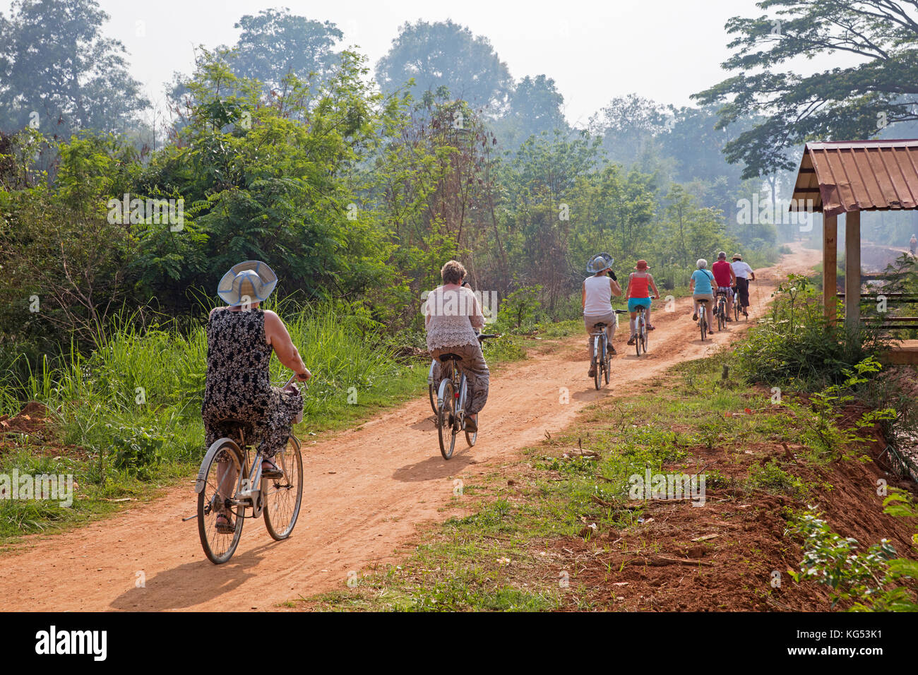 Western tourists cycling on bicycles near the Inle lake in the Nyaungshwe Township of Taunggyi District, Shan State, Myanmar / Burma Stock Photo