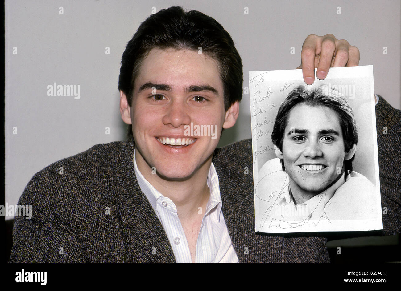 A young Jim  Carrey holds up an autogrpahed photo of himself in Los Angeles circa 1984 Stock Photo