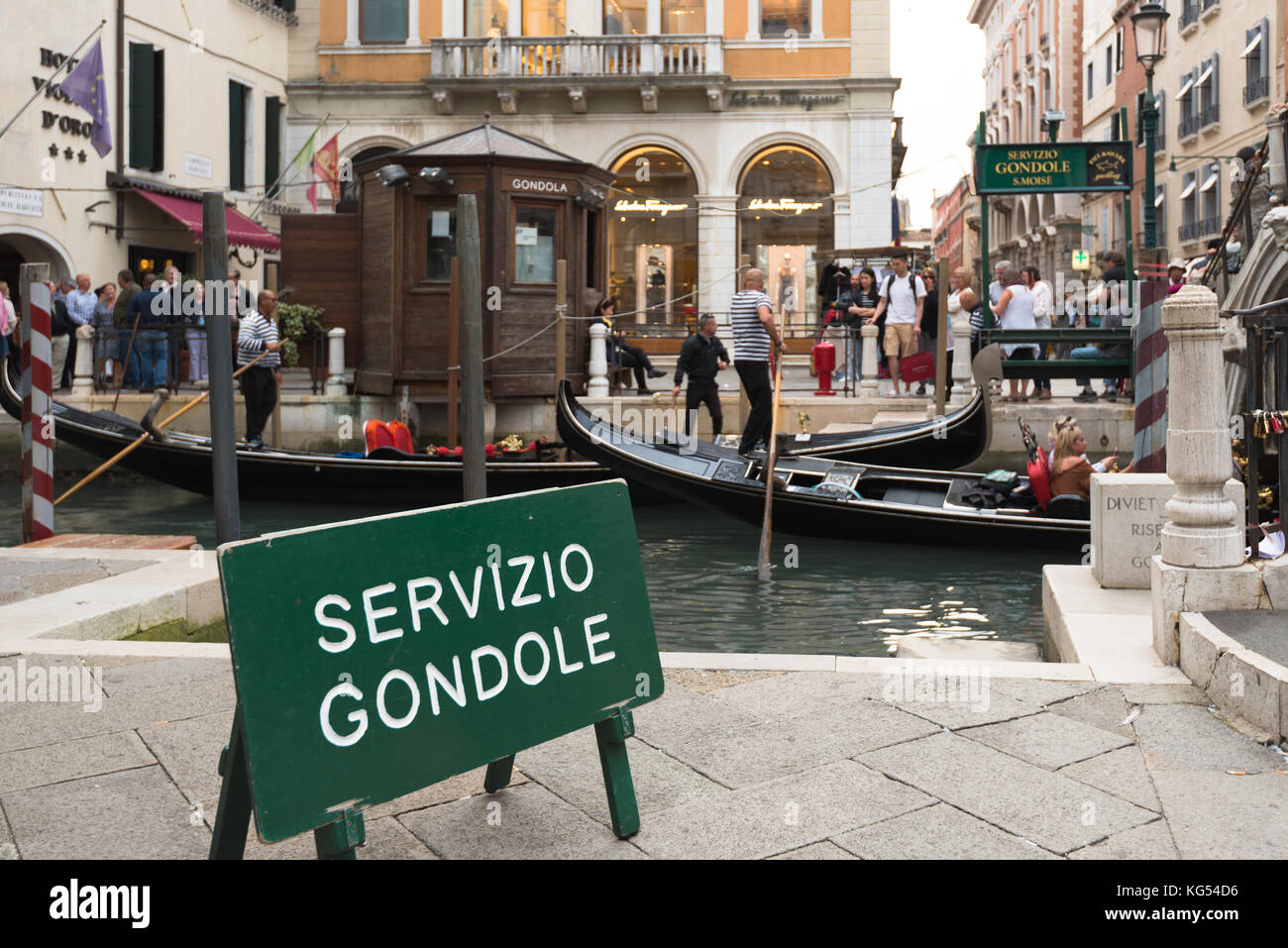 People entering the typical gondolas of Venice, Italy Stock Photo