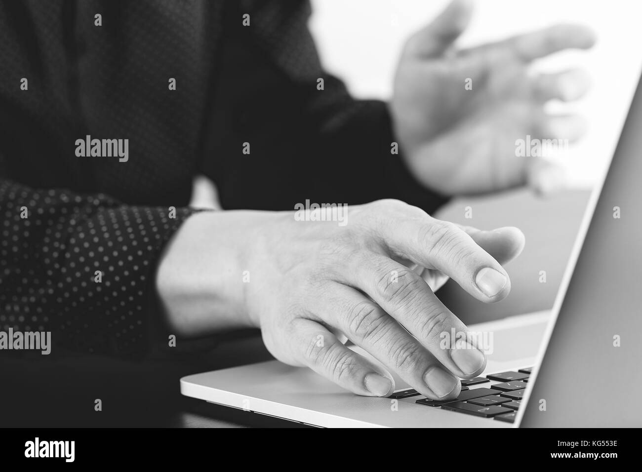 close up of businessman hand working with laptop computer in modern office,black and white Stock Photo