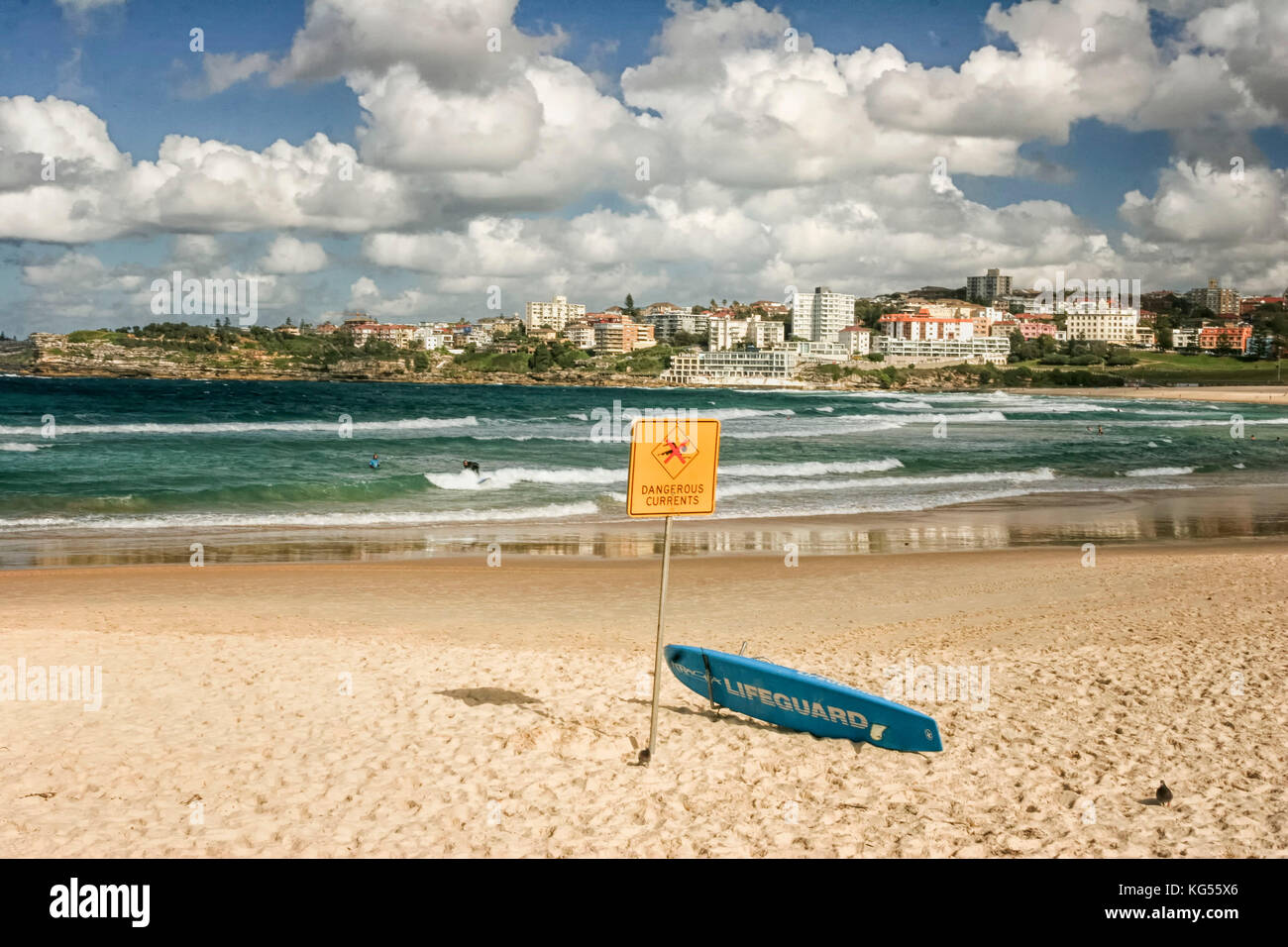 Blue surfboard against yellow dog sign on the world famous Bondai (Bondi beach) beach, Sydney New south Wales Australia under dramatic sky. Stock Photo