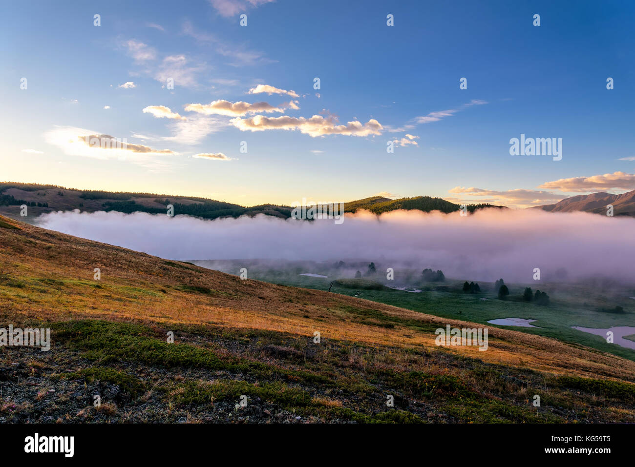 A picturesque landscape with mountains, beautiful mist over lakes ...