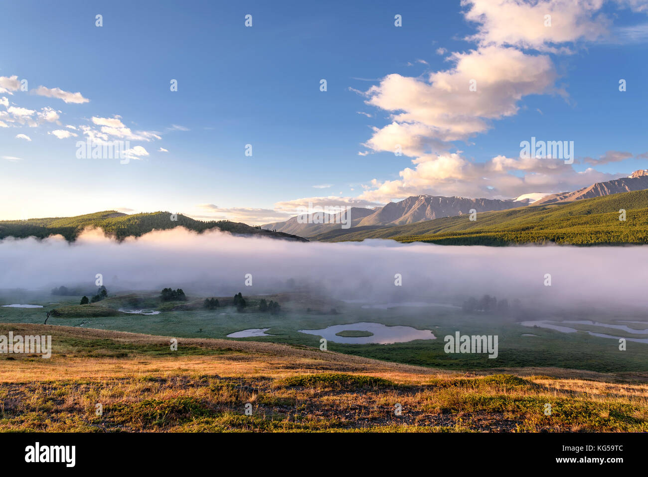 A picturesque landscape with mountains, beautiful mist over lakes ...