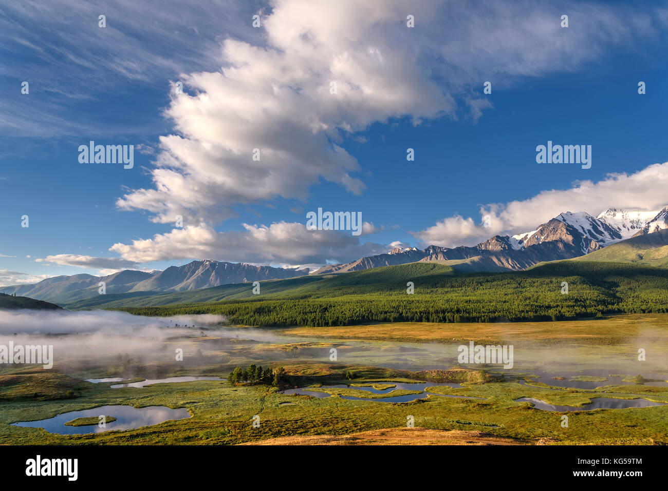 A picturesque landscape with mountains, beautiful mist over lakes ...
