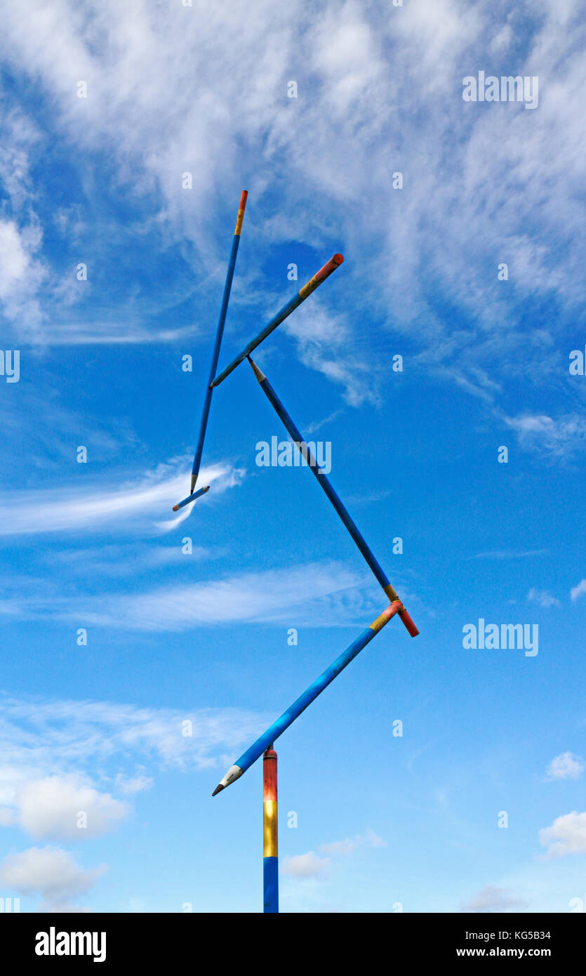 An art installation with the structure in motion and equilibrium against a blue sky. Stock Photo