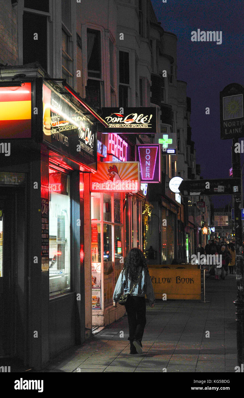 Variety of fast food outlets including Spanish tapas , Kebab shops and Fried Chicken in York Place Brighton at night Stock Photo