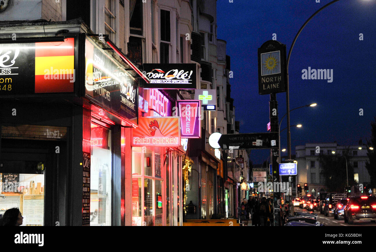 Variety of fast food outlets including Spanish tapas , Kebab shops and Fried Chicken in York Place Brighton at night Stock Photo