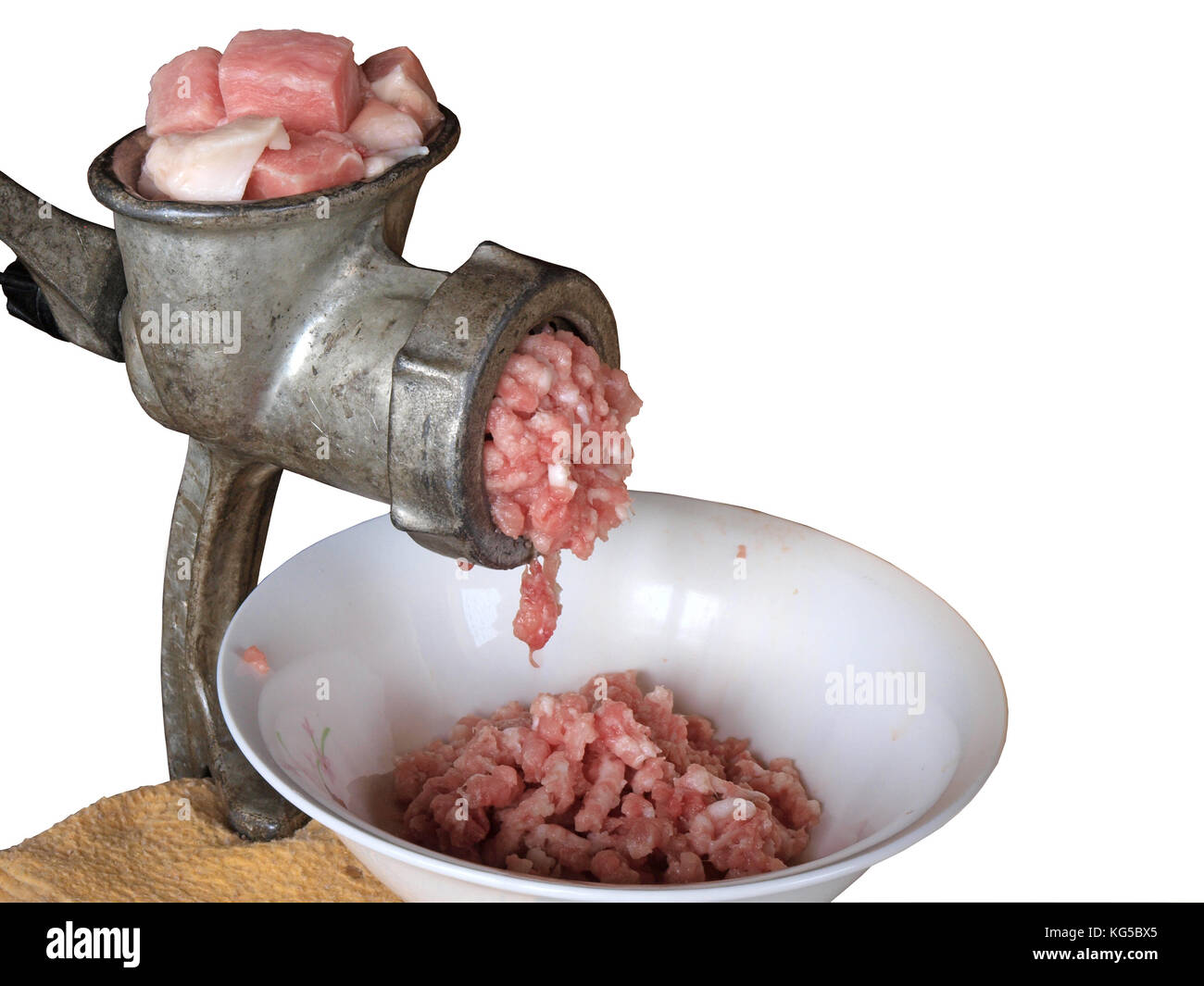 Hand powered meat grinder working isolated on white with copy space
