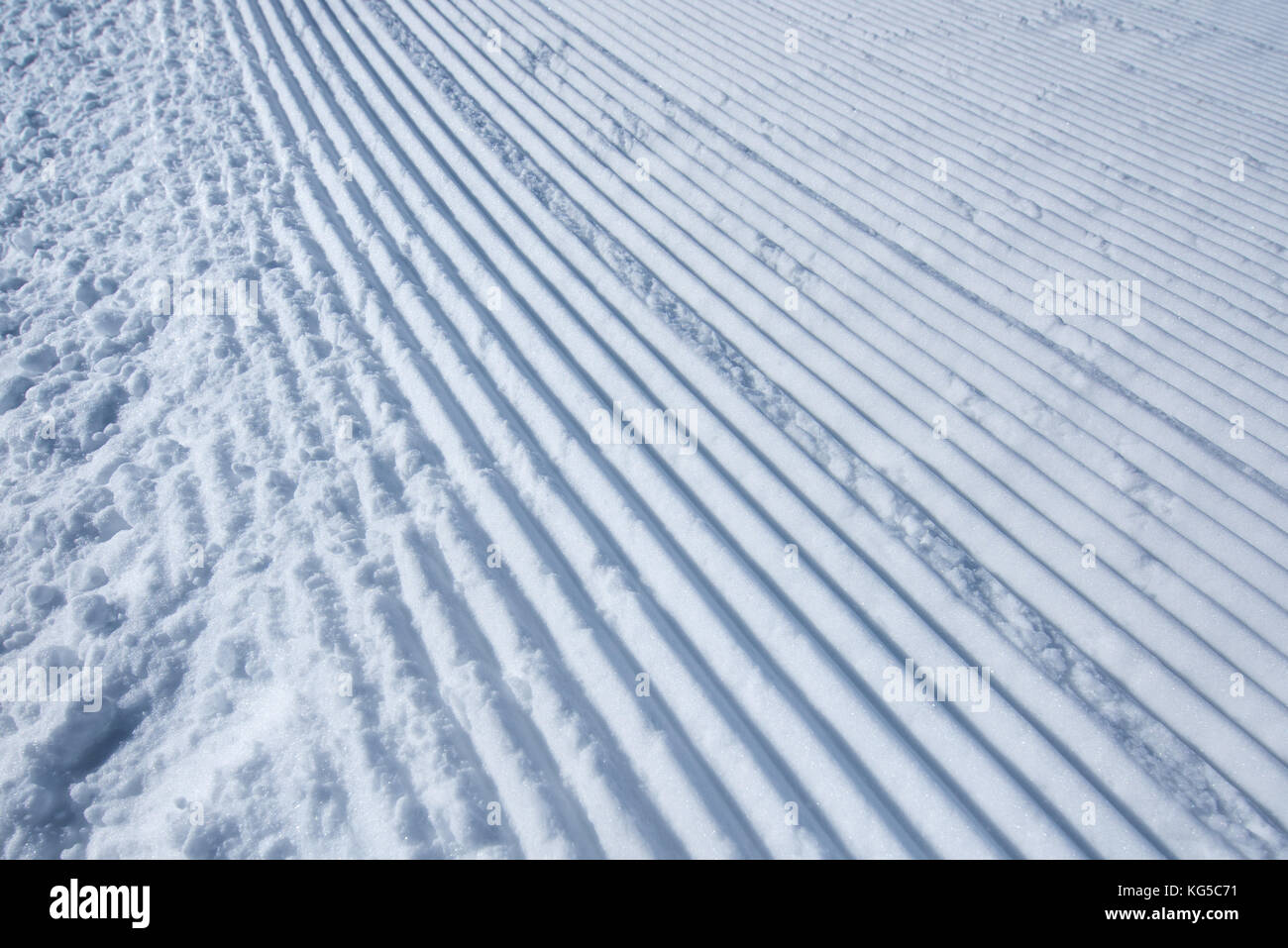 Groomed ski run track in snow, winter season background Stock Photo