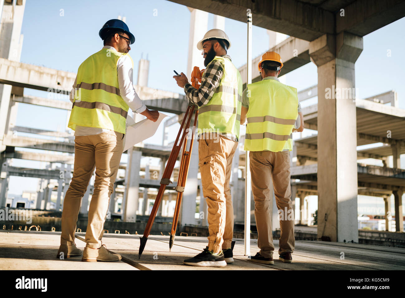 Team of construction engineers working on building site Stock Photo - Alamy
